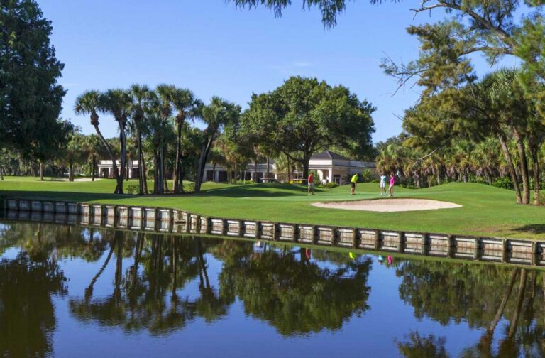 Golf course green and clubhouse across the water at Boca Royale, Englewood, Florida