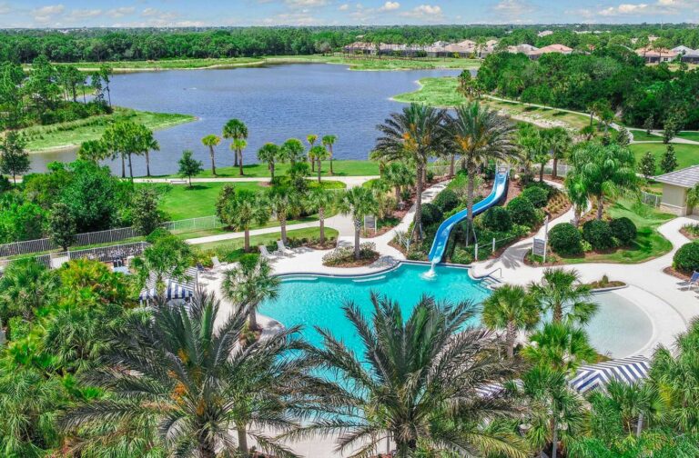 Resort-style pool with water slide beside the lake at Grand Palm, Venice, Florida