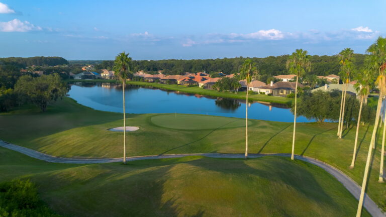 Golf course green with lake and homes at Heritage Harbour, Bradenton, Florida