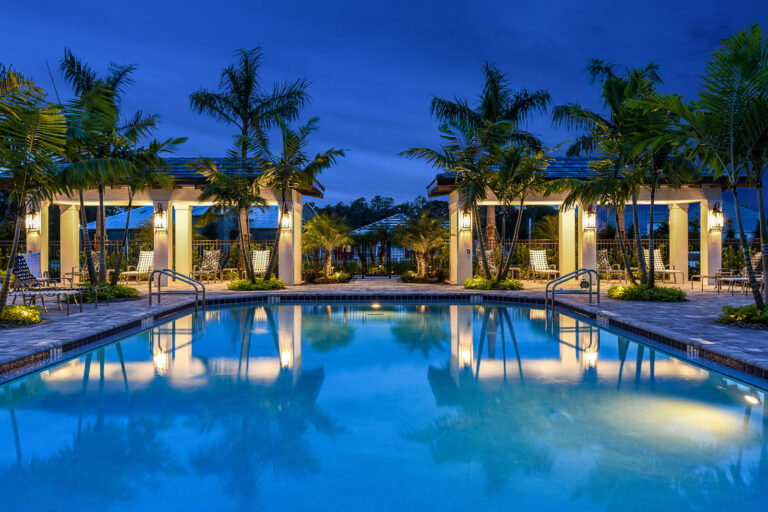 Villa amenity center pool and pavilions at dusk at Indigo, Lakewood Ranch, Florida