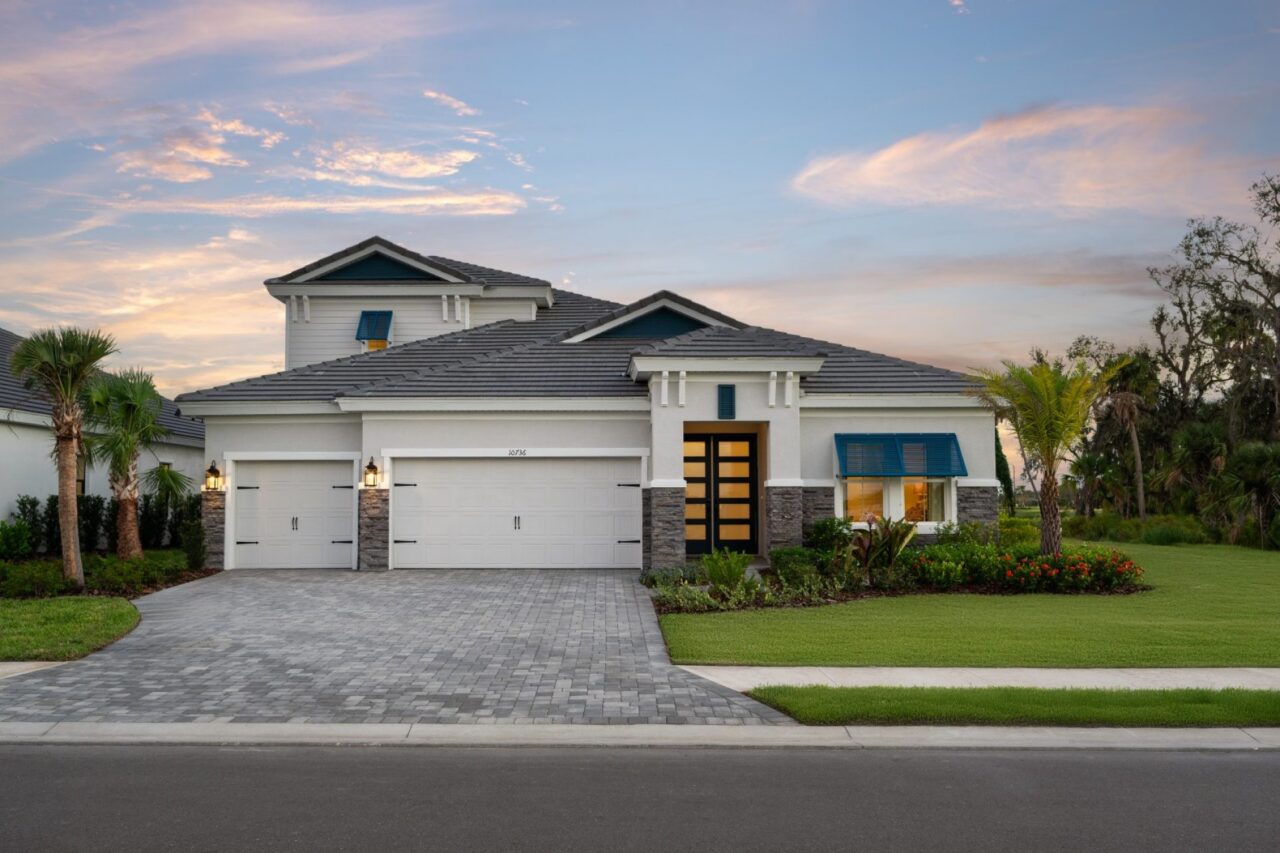 Bayport II model home exterior at dusk at Oakfield, Parrish, Florida