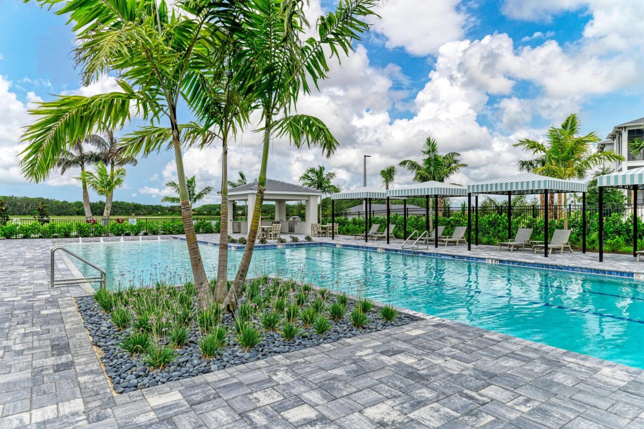 Lap pool, palms and cabanas at the amenity center at Inspiration at Watercolor Place, Bradenton, Florida