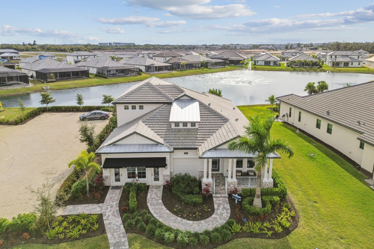 M/I Homes model and sales center overlooking a lake at Cassata Lakes, Venice, Florida