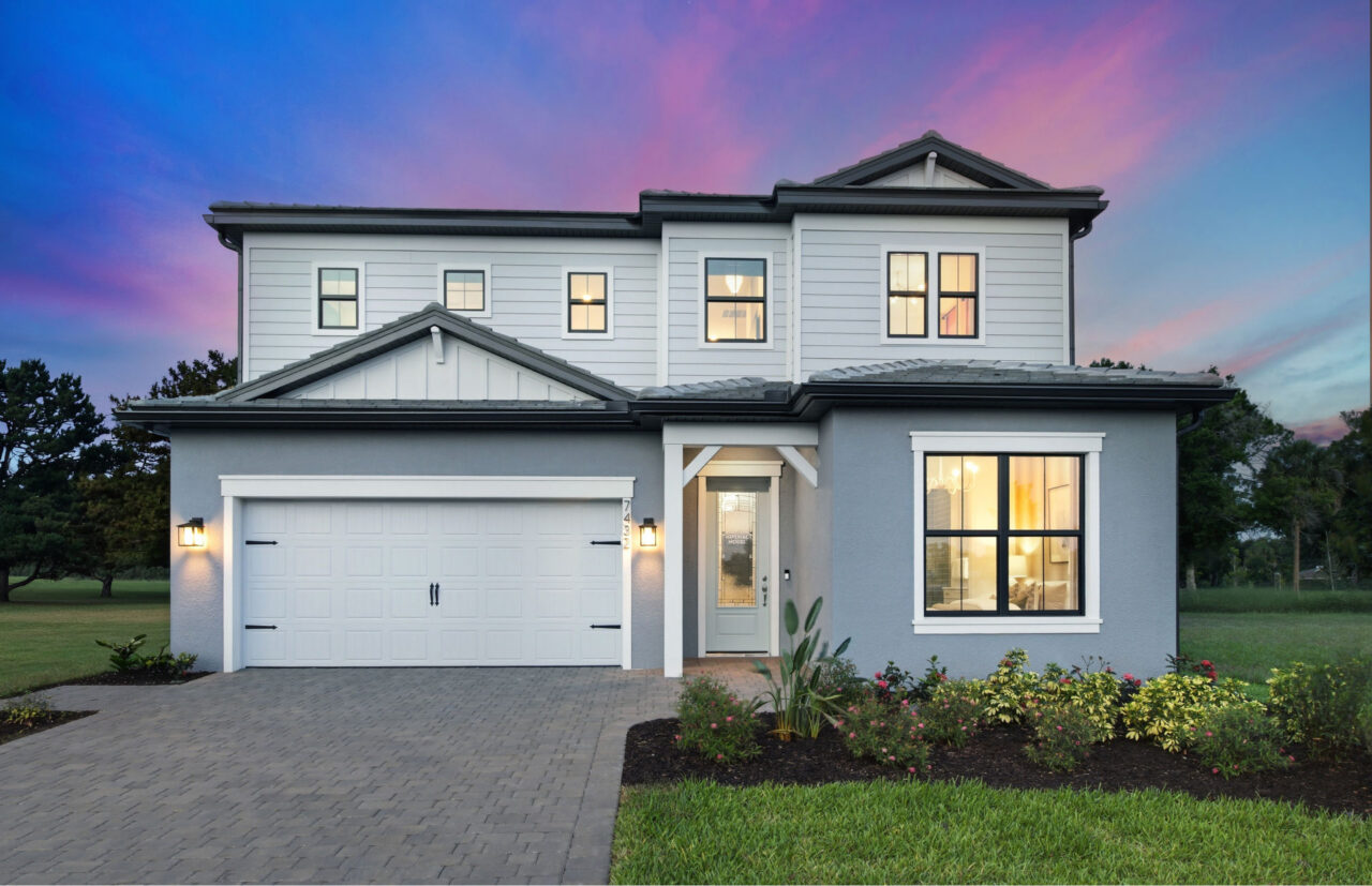 Two-story model home exterior at dusk at Grandura, Sarasota, Florida