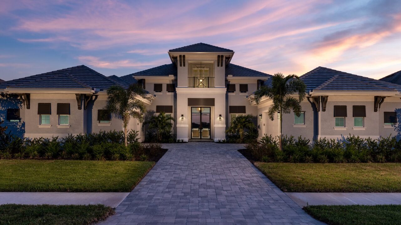 STOCK luxury home exterior at dusk at Wild Blue at Waterside, Lakewood Ranch, Florida