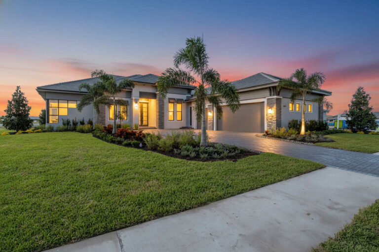 John Cannon custom home exterior at dusk at Wild Blue at Waterside, Lakewood Ranch, Florida