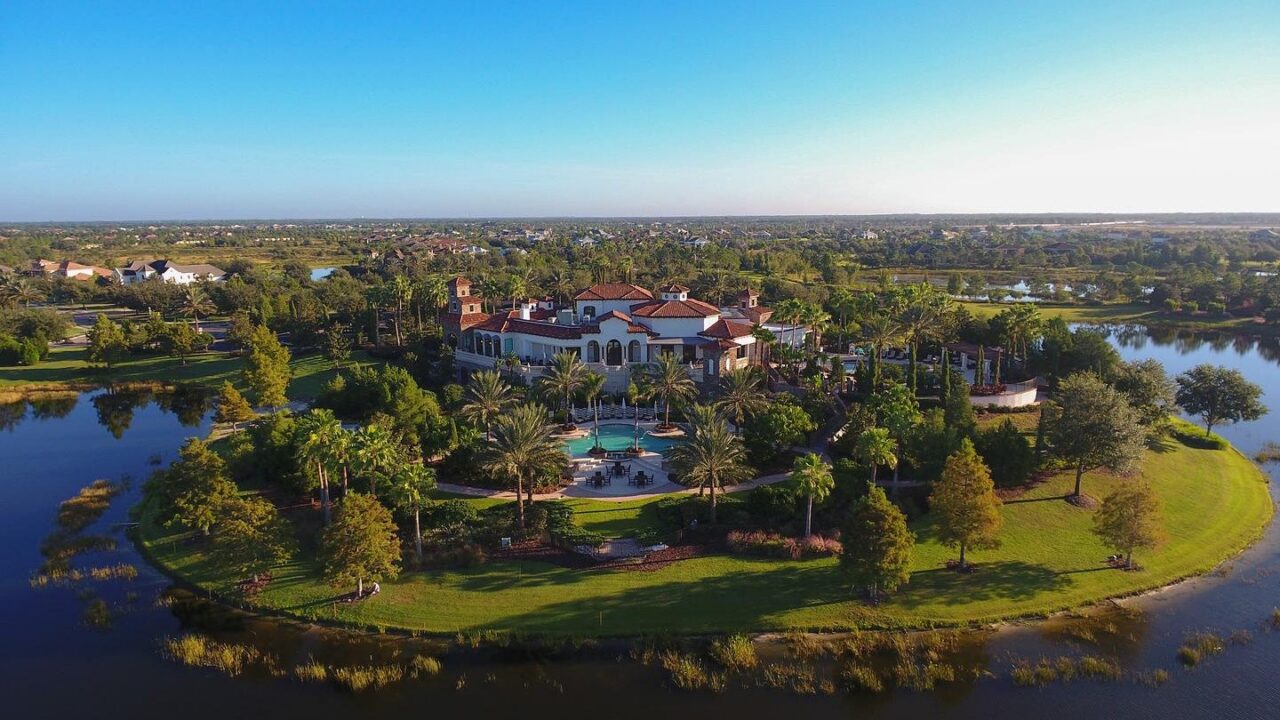 Aerial view of the Grande Clubhouse and lake at The Lake Club, Lakewood Ranch, Florida