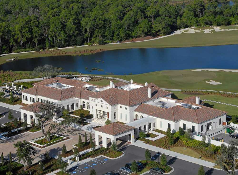 Aerial view of the clubhouse, lake and golf course at The Concession, Bradenton, Florida