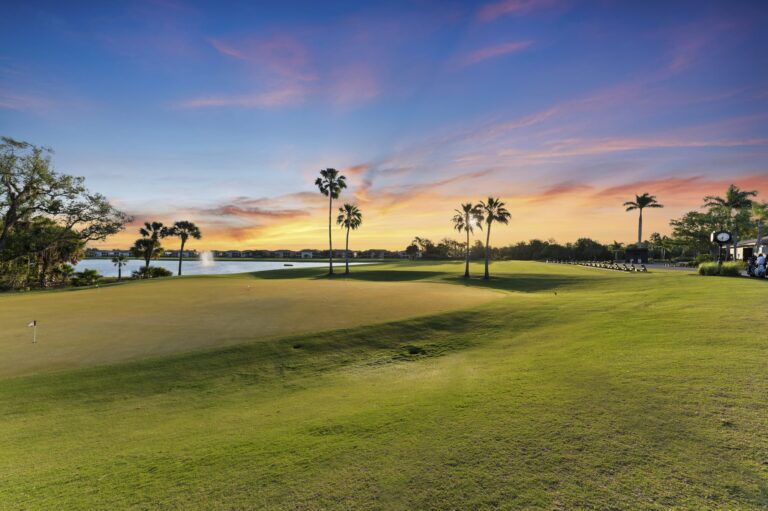 Golf course practice green and lake at sunset at River Strand, Bradenton, Florida
