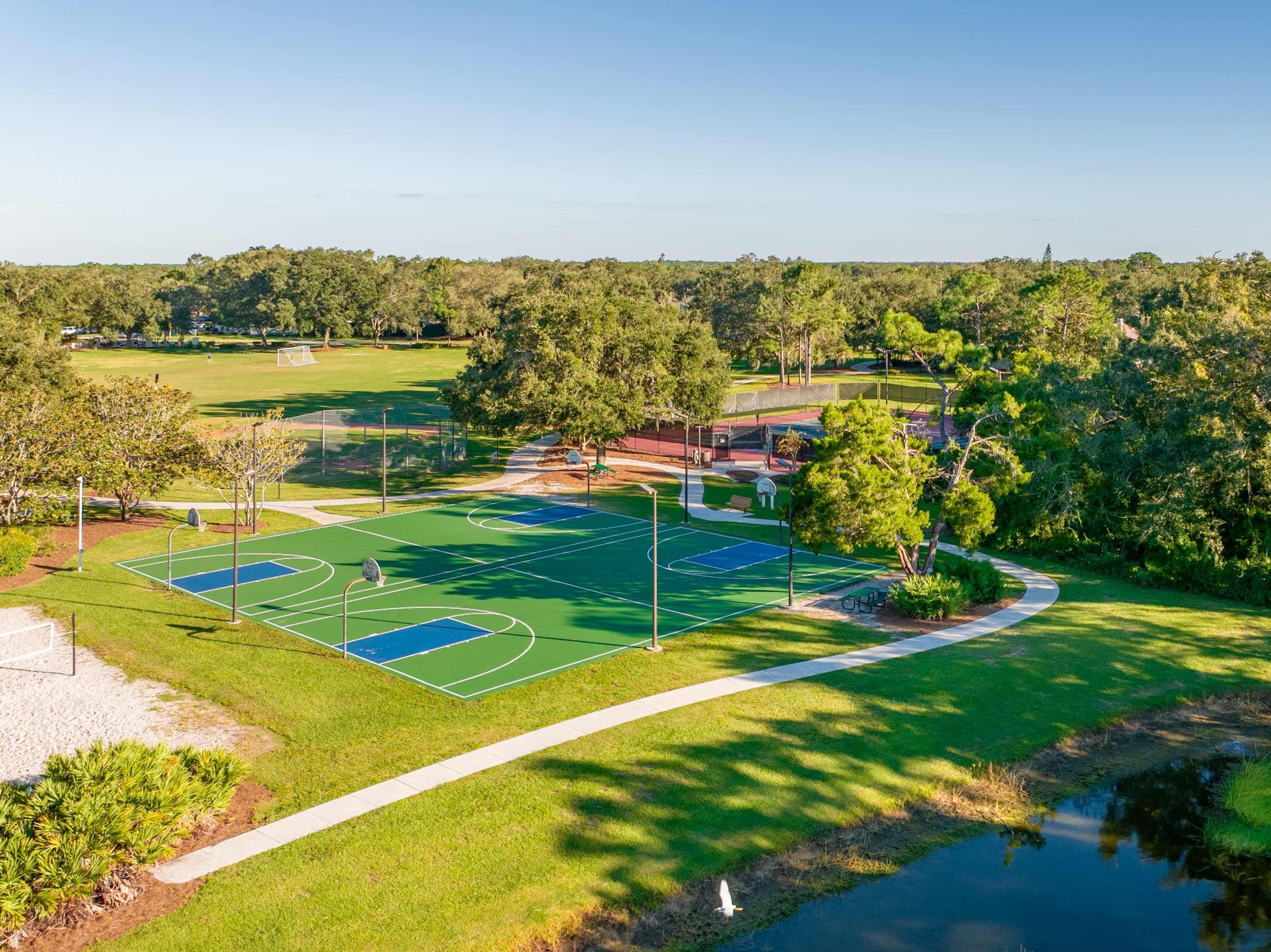 Aerial view of the courts, fields and pond at Summerfield Community Park at Summerfield at Lakewood Ranch
