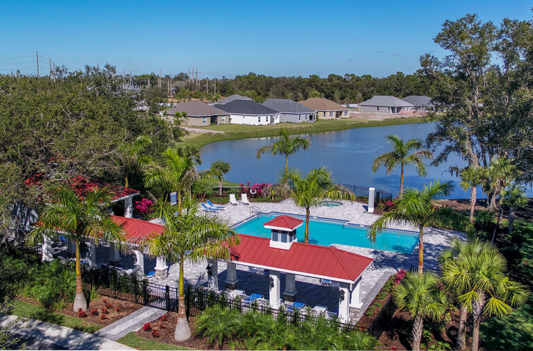 Resort-style pool, cabanas and lake at The Ridge at Crossing Creek, Bradenton, Florida